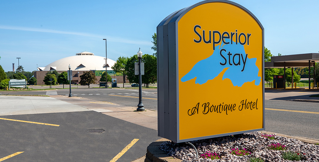 Superior stay hotel signage with superior dome in background