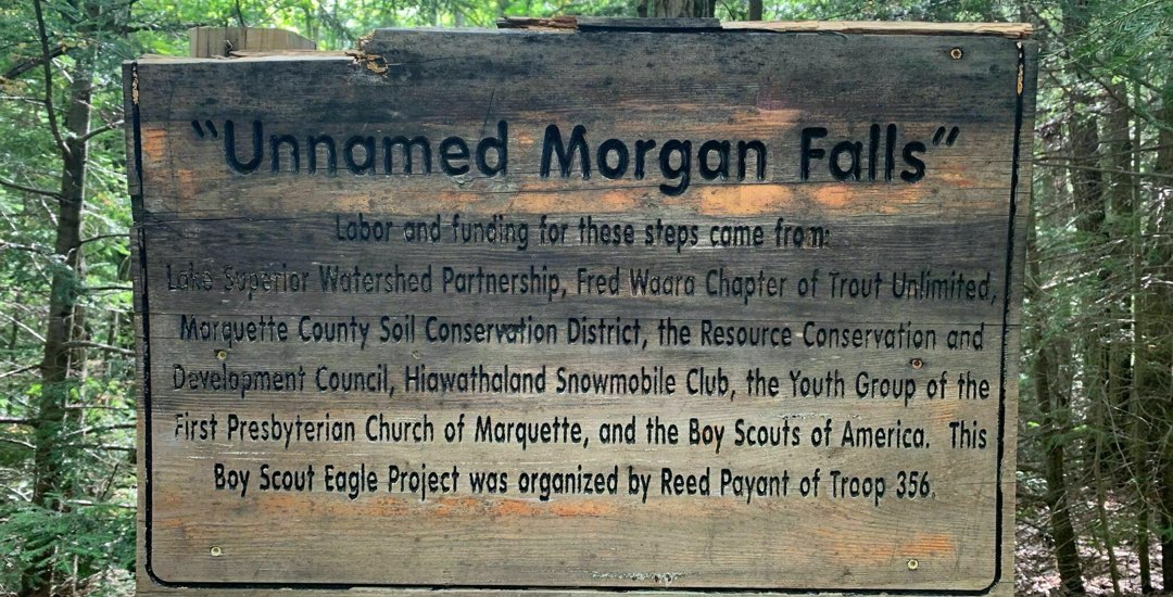 A Carved Wooden Board mentioning about the Source of labor and funding of Morgan Falls
